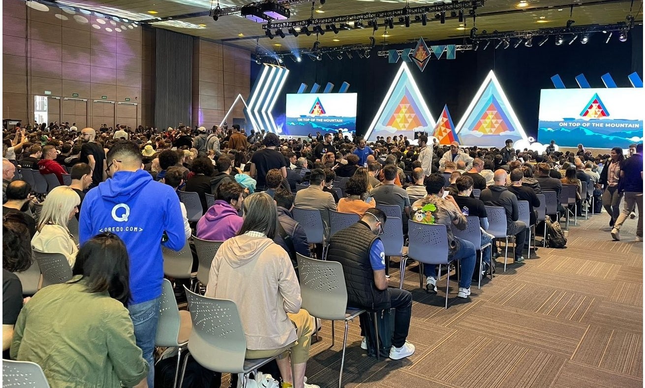 A full auditorium at Devcon, under the On Top of the Mountain stage set
